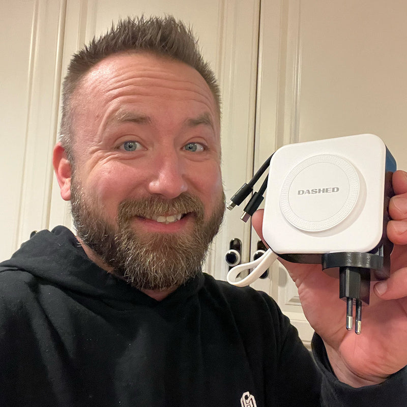Man Smiling holding Dashed Travel Charger