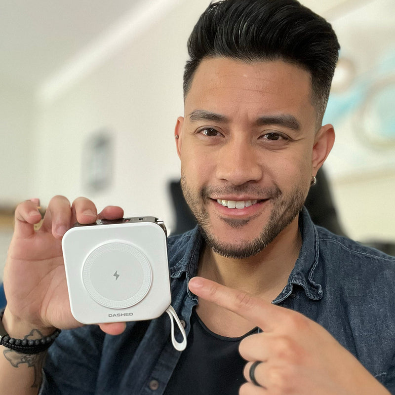 Man holding White Travel Charger pointing at it