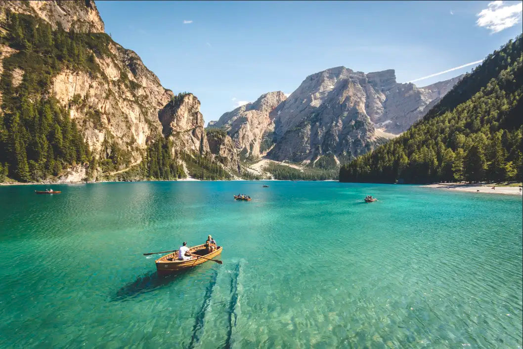 Boat on a clear lake with mountains in the background