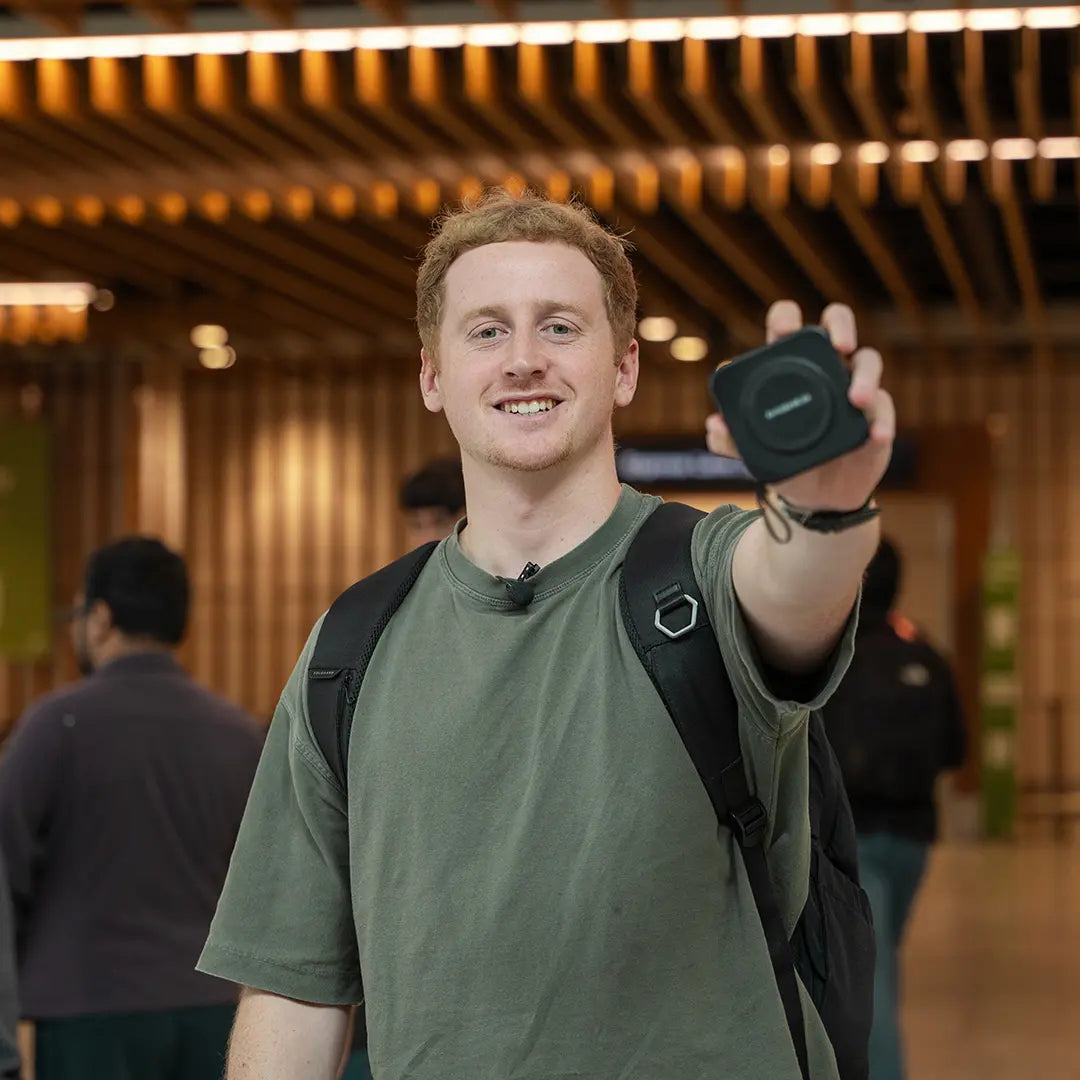 Man showing travel charger in airport